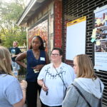 A group of TNS participants gathered around Union Studio staff discussing their interests and wants for the construction of Adam's Way.